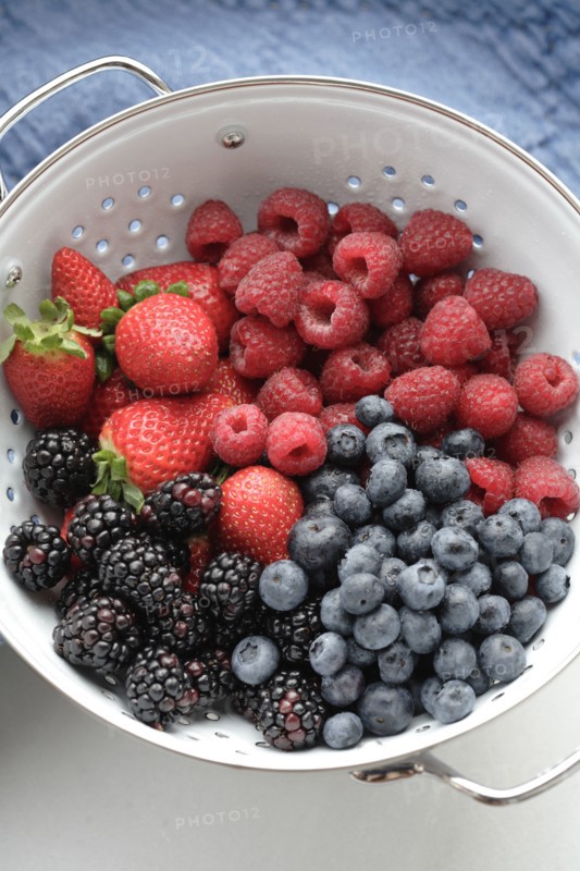 Various fresh berries in colander