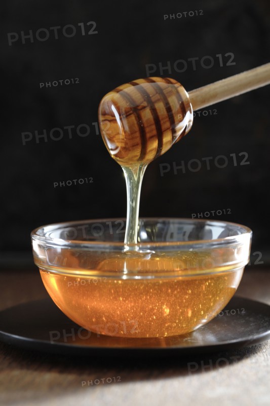 Honey dripping off of dipper