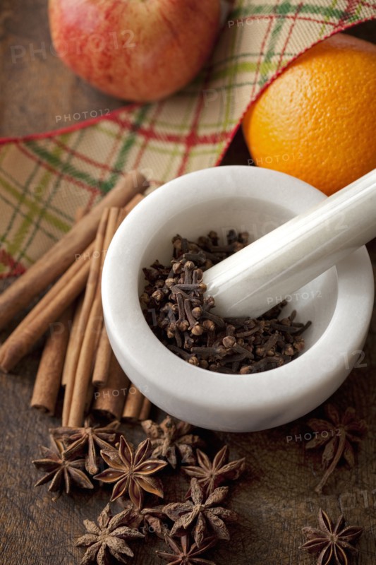 Fruit with spices in pestle and mortar
