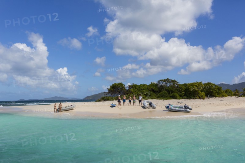 Tourists standing on tropical beach