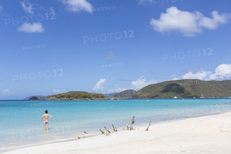 Caucasian woman standing in ocean on tropical beach