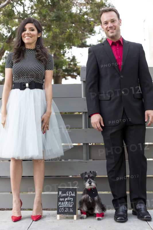 Couple with dog near wedding announcement