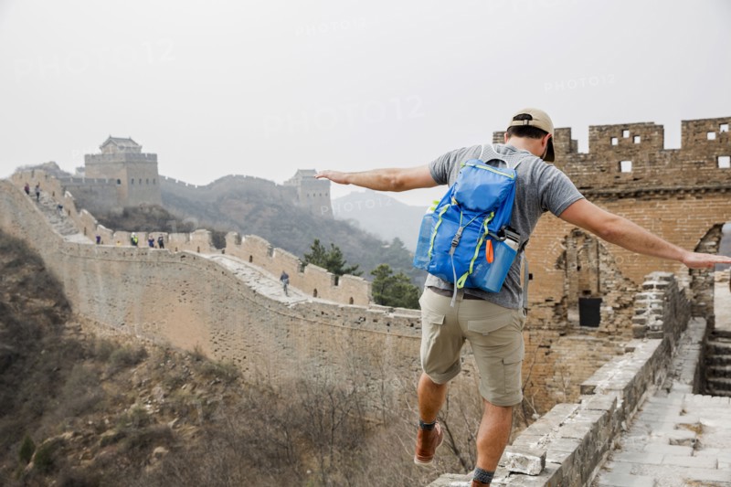 Tourist balancing on Great Wall of China