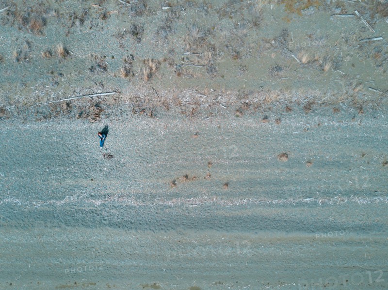 Aerial view of Caucasian woman sitting on beach