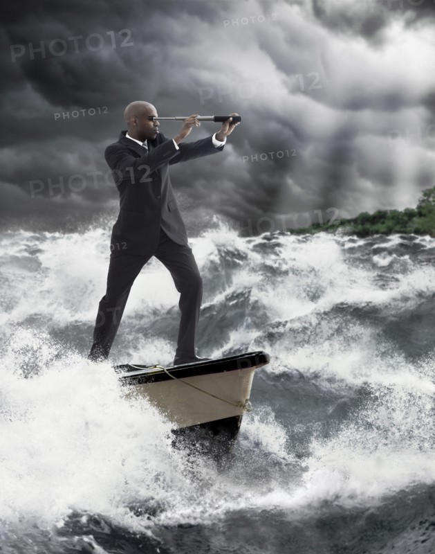 African American businessman using telescope on boat