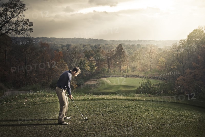 Caucasian man playing golf