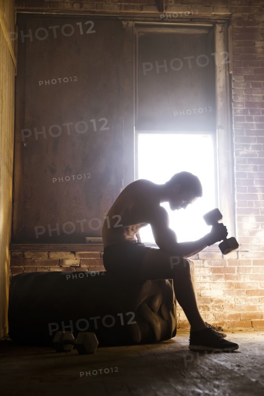 Caucasian man exercising with dumbbells