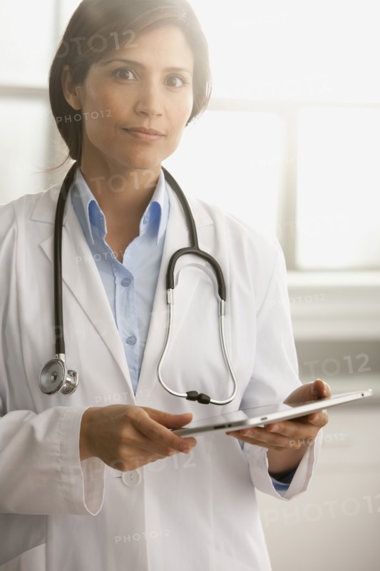 Hispanic doctor using digital tablet