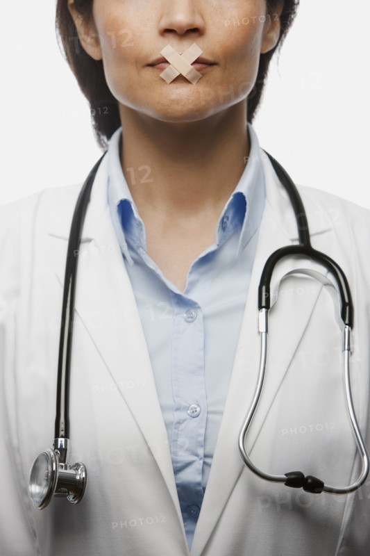 Hispanic doctor with bandages on mouth