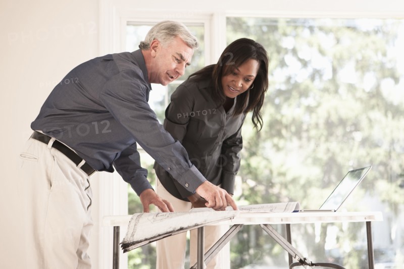 Man and woman looking at blueprints together