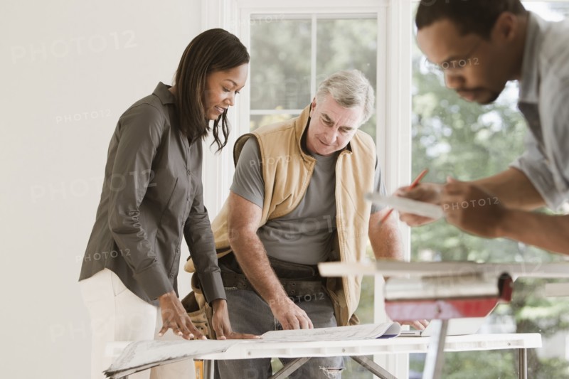 Man and woman looking at blueprints together