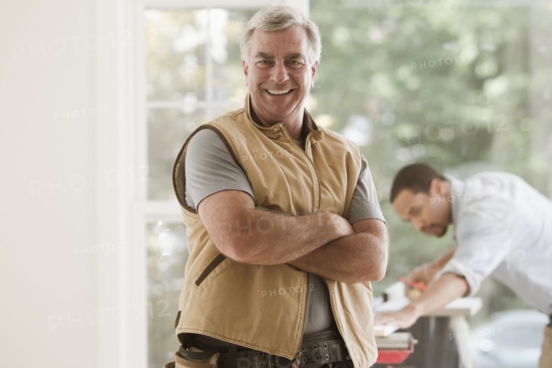 Caucasian carpenter standing with arms crossed