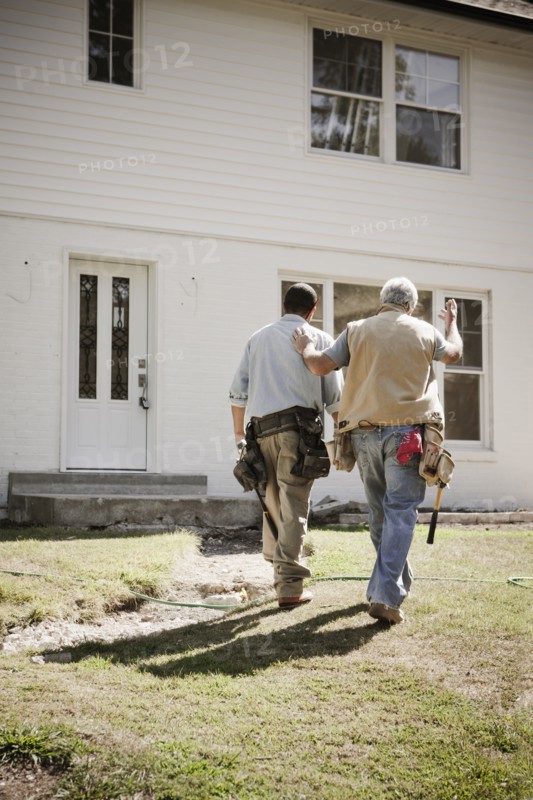 Carpenters walking toward house