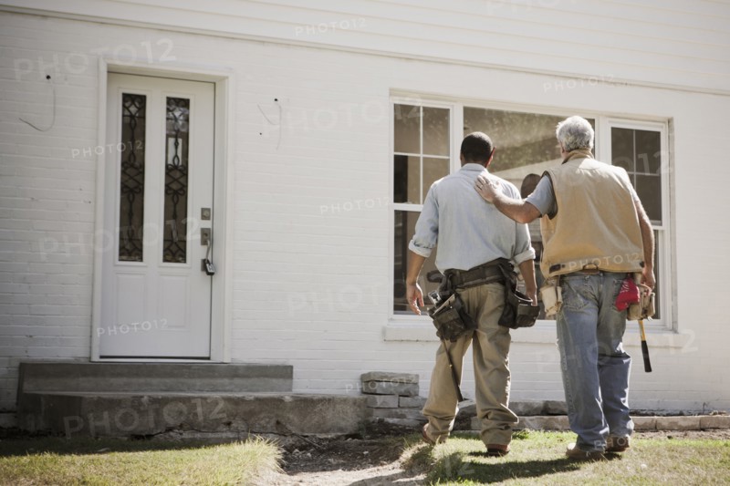 Carpenters walking toward house