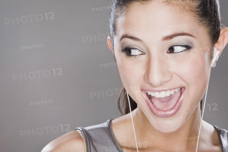 Smiling mixed race woman listening to headphones