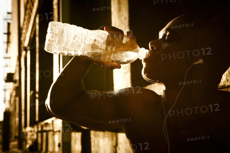 African American man drinking water after exercise
