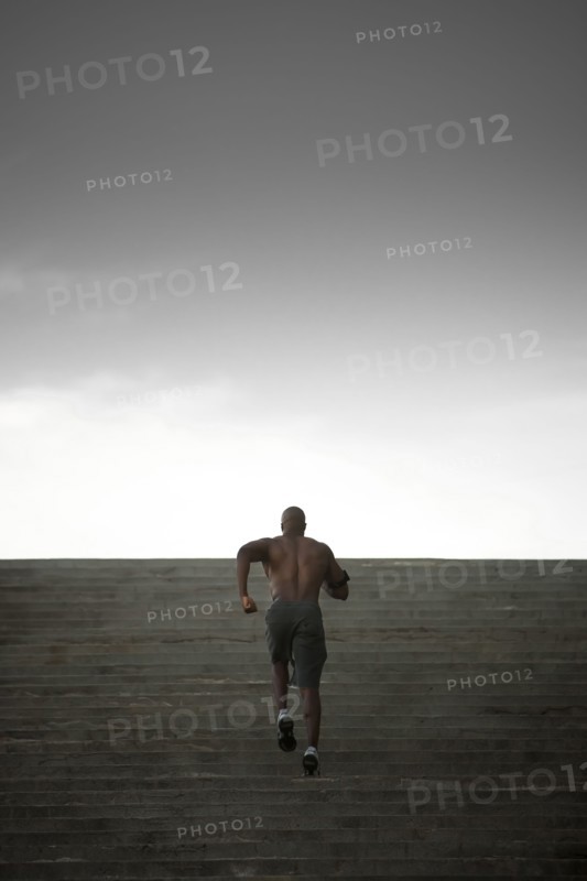 Black man running up stairs