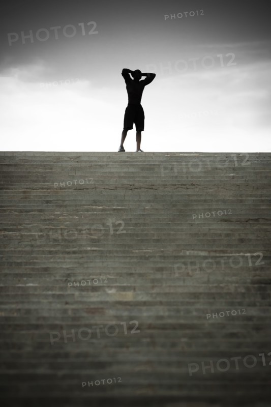 Black man stopping at top of stairs