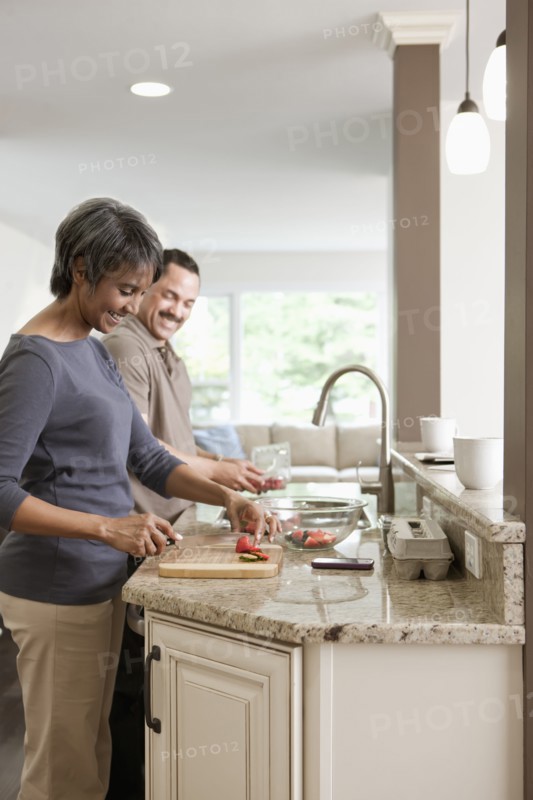 Couple preparing meal together in kitchen