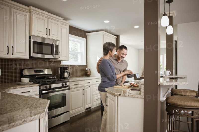 Couple preparing meal together in kitchen