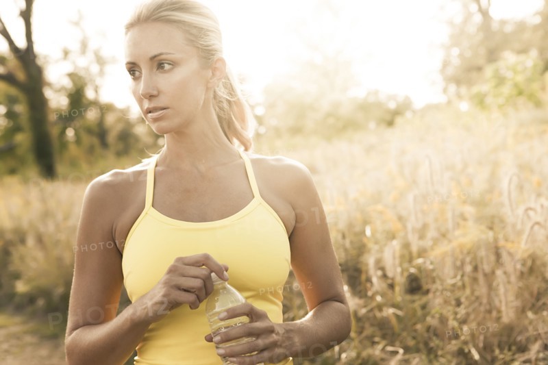 Caucasian woman holding water bottle outdoors