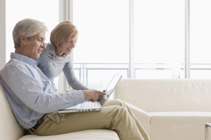 Caucasian couple using laptop together