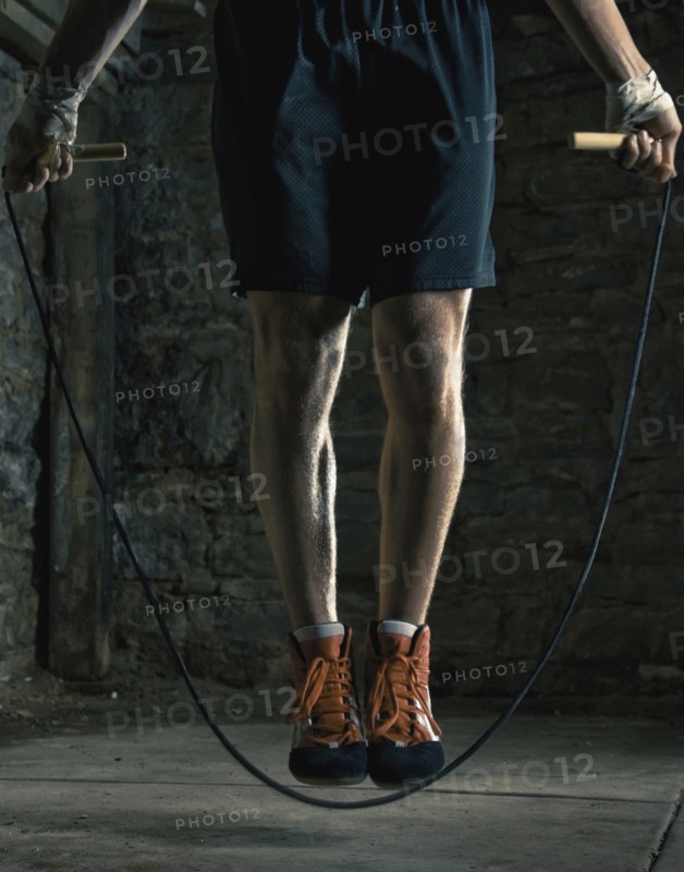 Caucasian boxer training and jumping rope