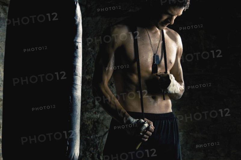 Caucasian boxer standing near punching bag
