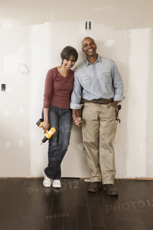 Couple holding hands in unfinished room