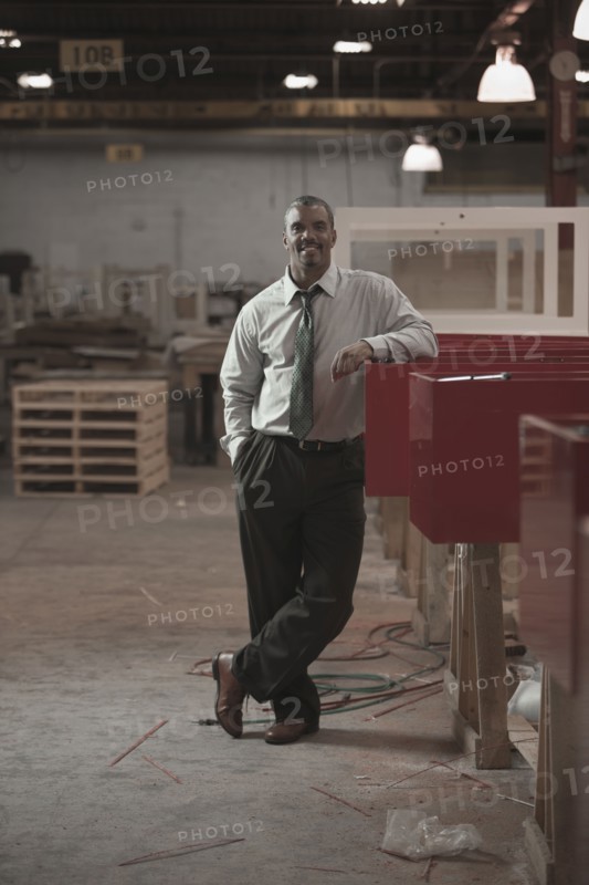 Black businessman standing in warehouse