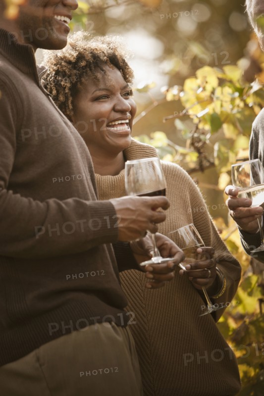 Friends drinking wine in vineyard