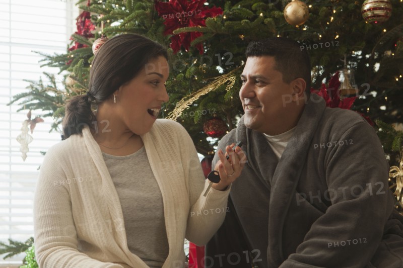 Wife opening keys to new car on Christmas morning