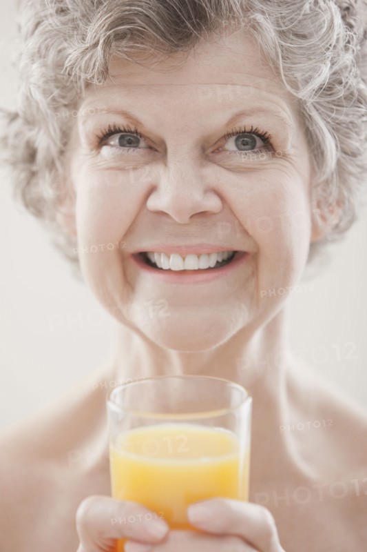 Caucasian woman drinking orange juice
