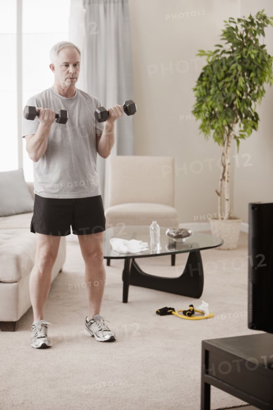 Caucasian man exercising in living room
