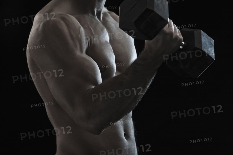 Caucasian man exercising with hand weights