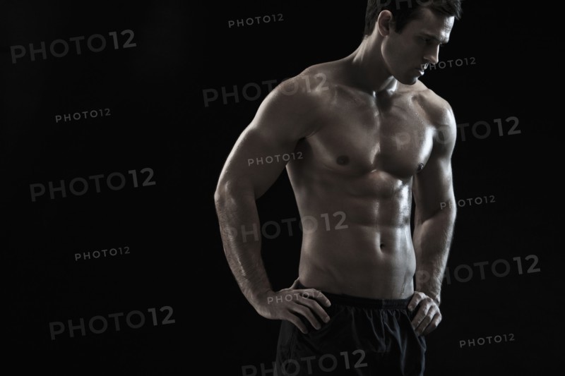 Bare chested Caucasian man with hands on hips