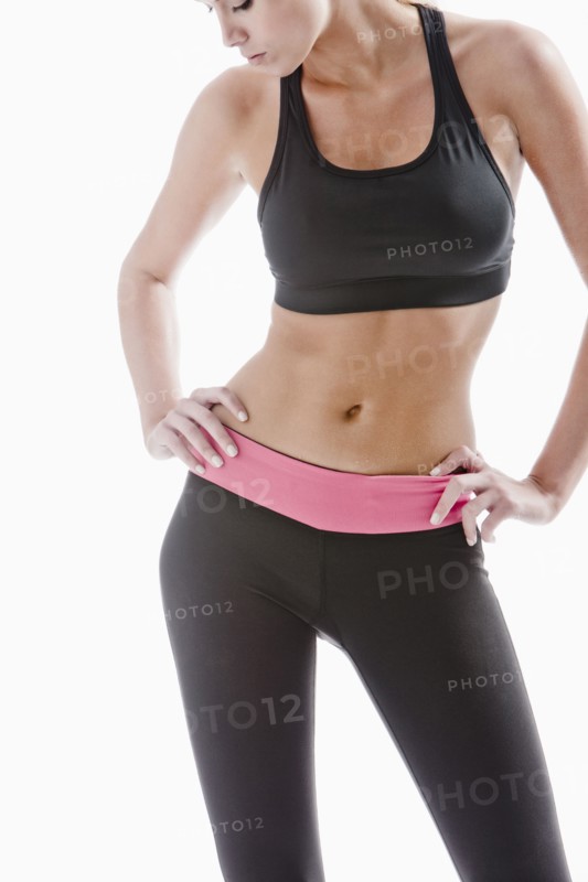 Caucasian woman in sportswear standing with hands on hips