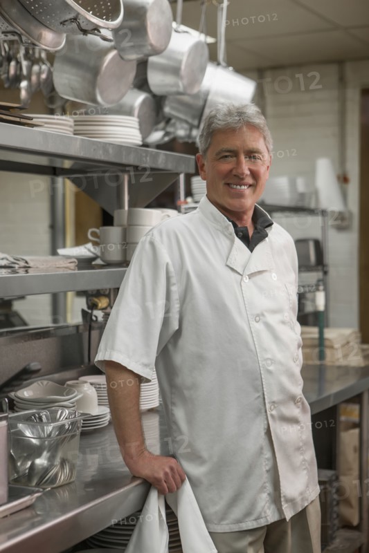 Caucasian chef standing in commercial kitchen