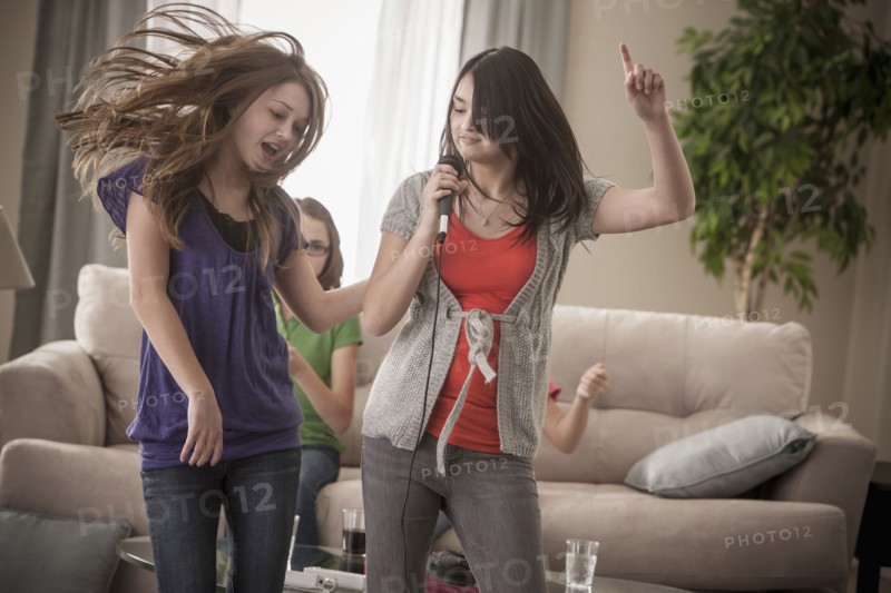 Friends singing karaoke together