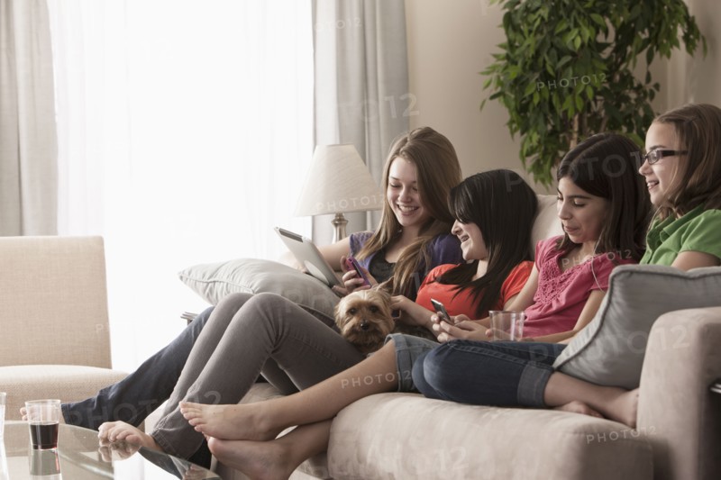 Friends hanging out on sofa together
