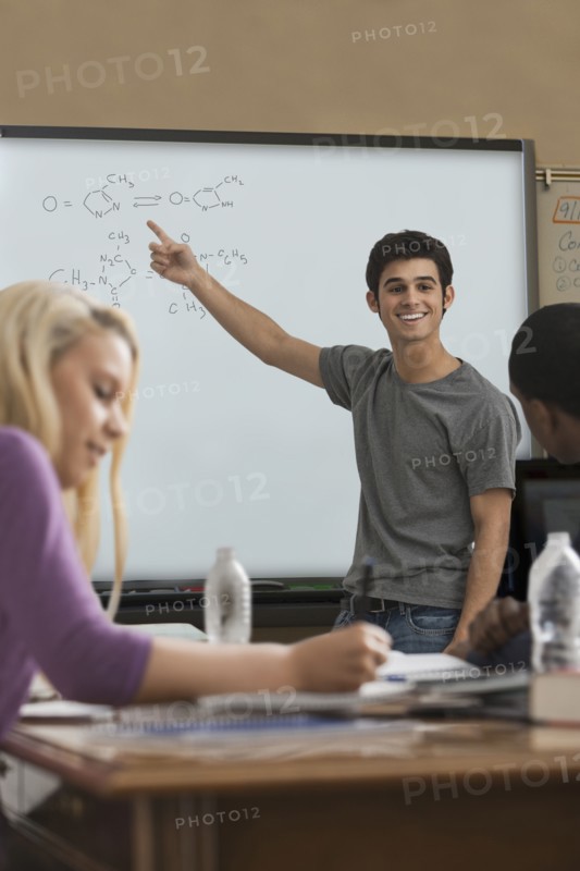 Student explaining formula in classroom