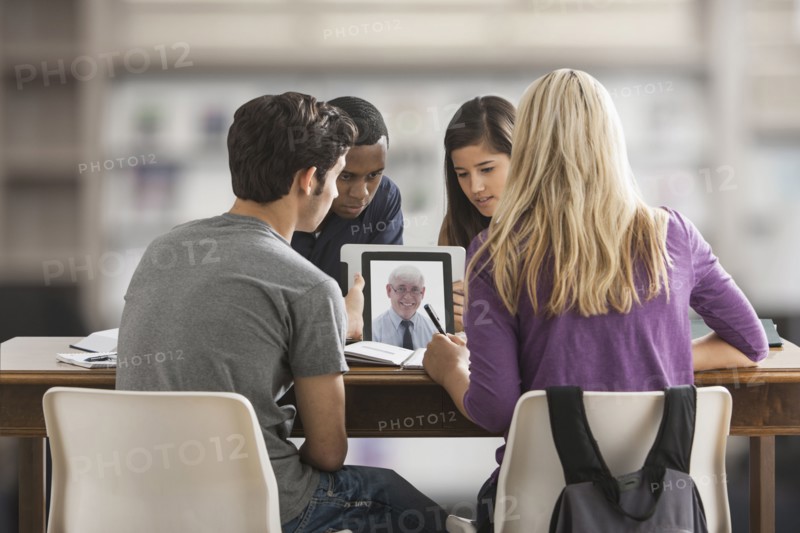 Friends studying together using digital tablet
