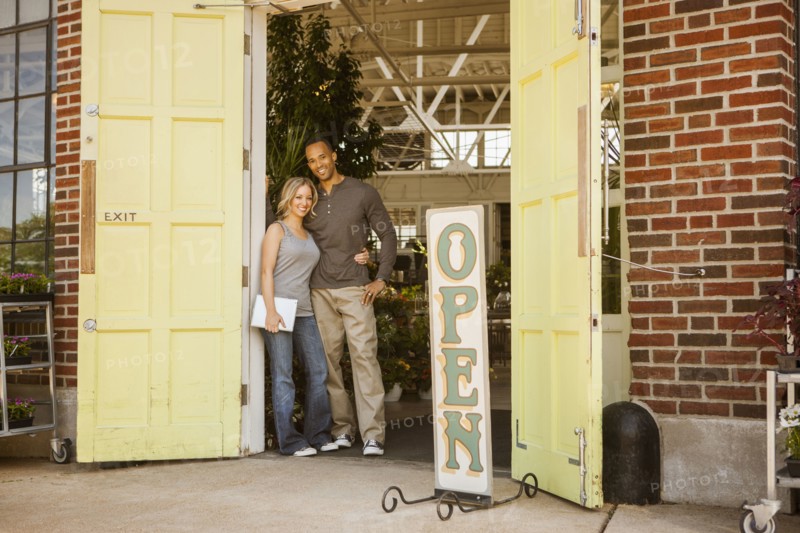 Couple standing in flower shop doorway