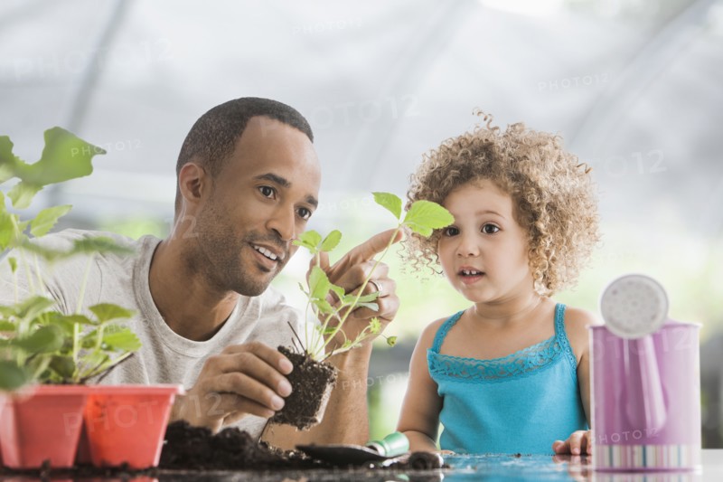 Father and daughter gardening together