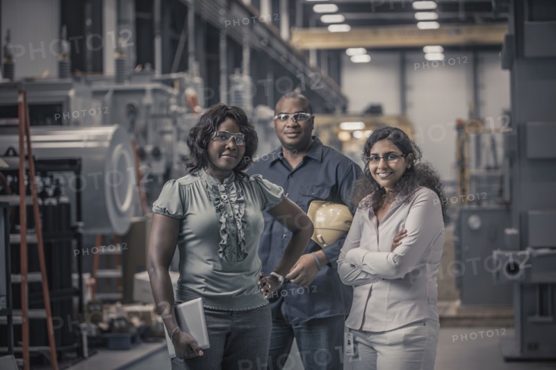Workers standing together in factory