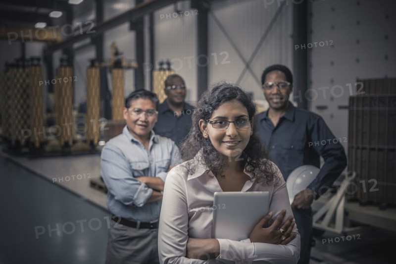 Workers standing together in factory
