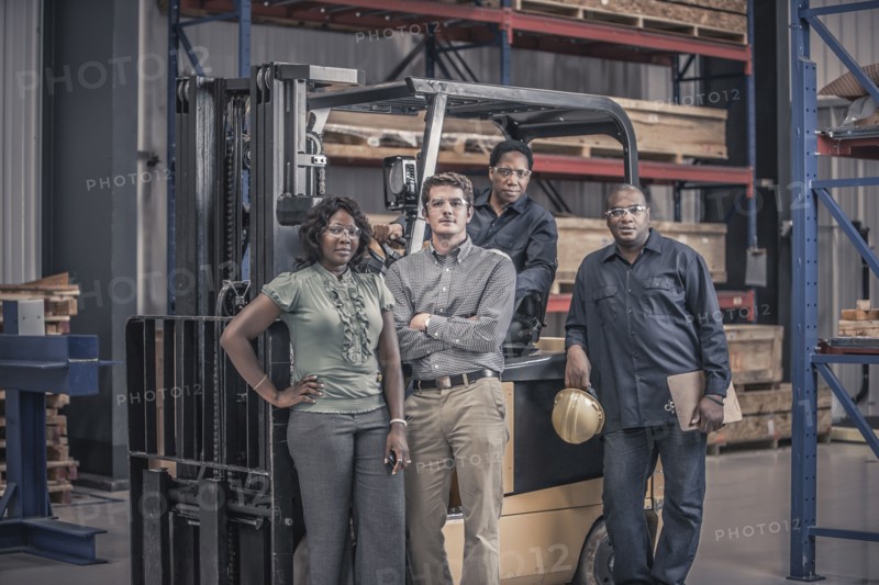 Workers with forklift in factory