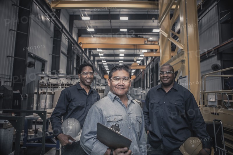 Workers standing together in factory
