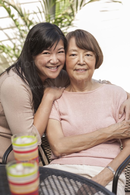 Asian mother and daughter hugging