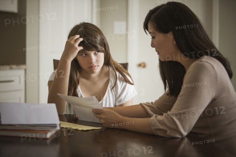 Mother helping daughter with homework